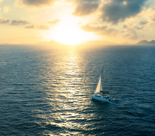 Pay-Per-Cabin Sailing - catamaran sailing at sunset