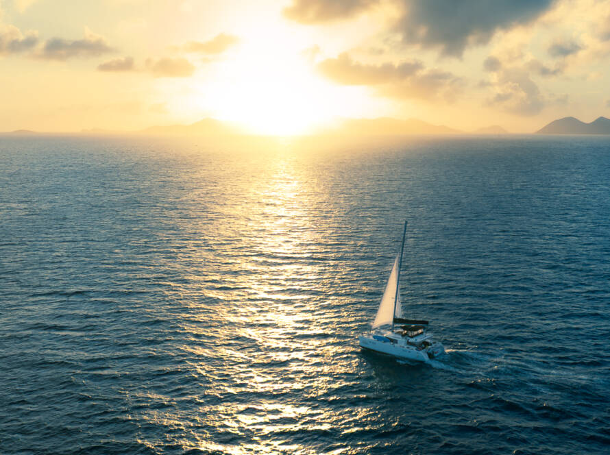 Pay-Per-Cabin Sailing - catamaran sailing at sunset