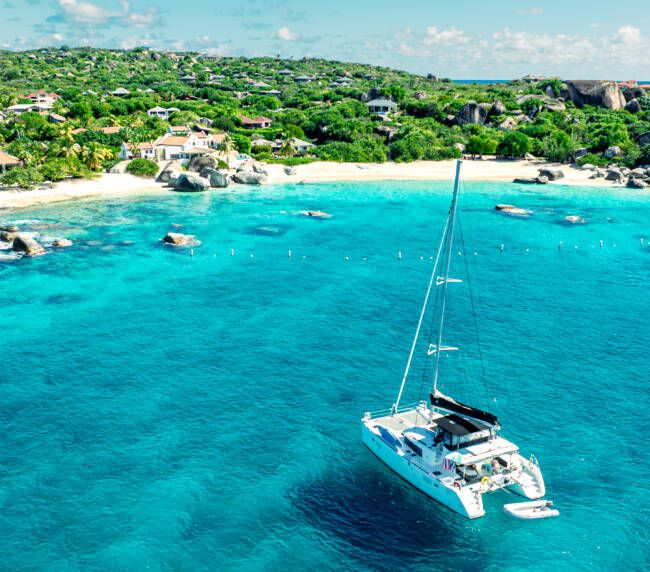 BVI yacht charter cost comparison — catamaran moored at the baths Virgin gorda