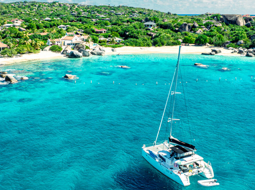 BVI yacht charter cost comparison — catamaran moored at the baths Virgin gorda