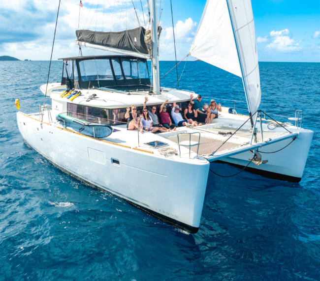 Guest with no sailing experience relaxing on a crewed catamaran in the BVI