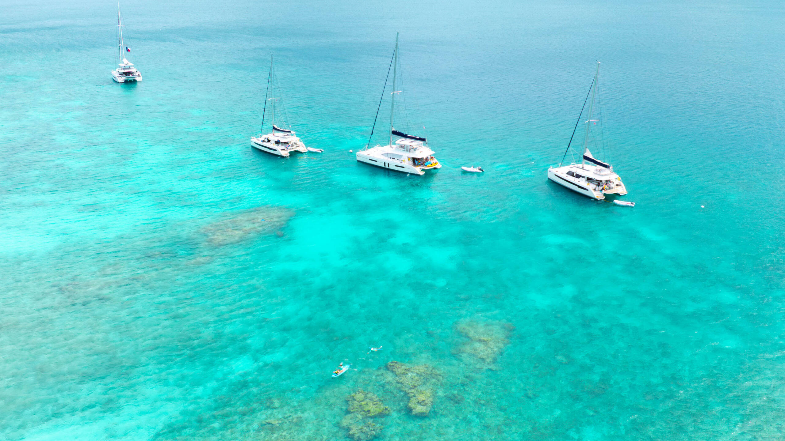 Professional captain ferrying guests between boats by dinghy on a flotilla