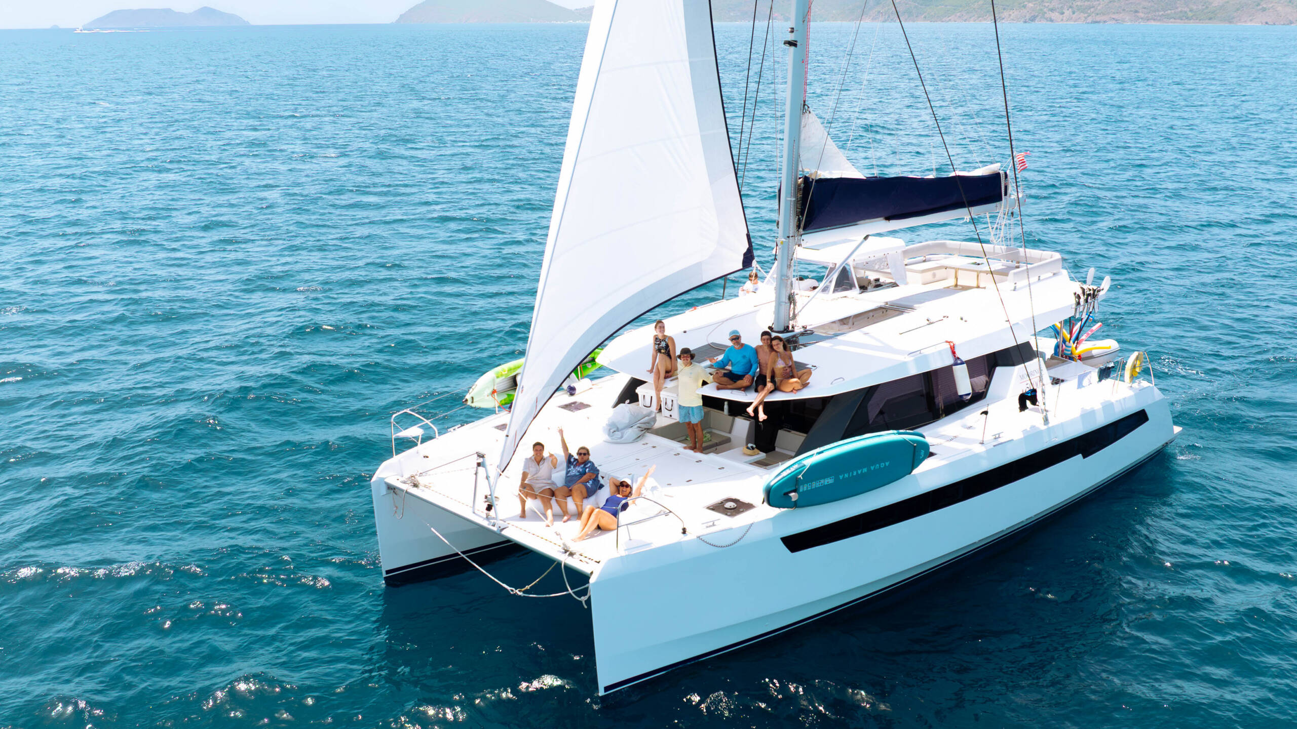 Large group of catamarans sailing together through the British Virgin Islands